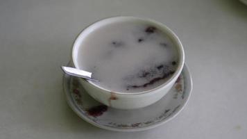 Indonesian black sticky rice porridge, which is very popular with people for dessert at a meal photo