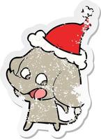 cute distressed sticker cartoon of a elephant wearing santa hat vector