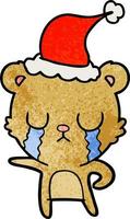 crying textured cartoon of a bear wearing santa hat vector
