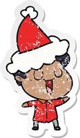 laughing distressed sticker cartoon of a man wearing santa hat vector