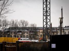 Vilnius, Lithuania, 2022 - The construction site on the old railway behind a fence with writing in two languages russian and lithuanian Gate Nr.4 photo