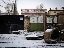 Vilnius, Lithuania, 2022 - The construction site on the old railway behind a fence with writing in lithuanian and russian Gate Nr.4 and Strangers are not Allowed to Enter on green gates photo