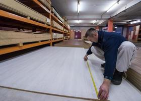 carpenter measuring wooden board photo