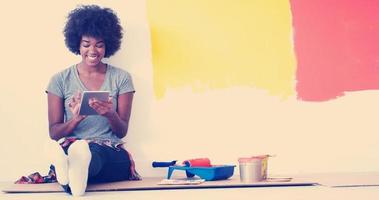 black female painter sitting on floor photo