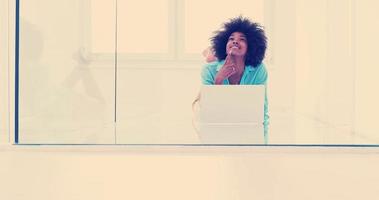 black women using laptop computer on the floor photo