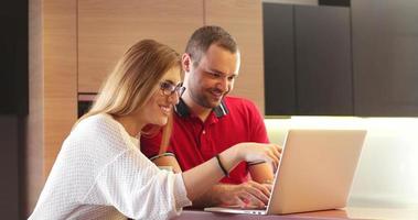 Couple Using Laptop To Shop Online in modern apartment photo