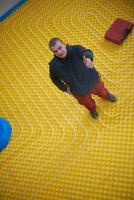 workers installing underfloor heating system photo