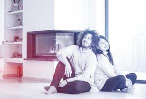 happy multiethnic couple  in front of fireplace photo