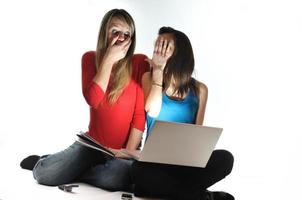 two young girls work on laptop isolated photo