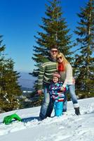 family having fun on fresh snow at winter photo