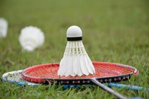 Badminton outdoors equipments shuttlecocks and badminton rackets, on grasslawn, soft and selective focus on shuttlecocks, outdoor badminton playing concept photo