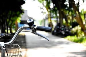 a handle of vintage bike which parked on the meadow background, soft and selective focus on hand. photo