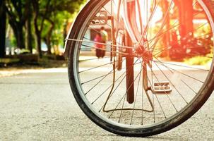 Closeup view of rear flat tire of vintage bicycle which parked on pavement beside the road. soft and selective focus. photo