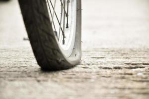 Bike flat tire on pavement, soft and selective focus. photo