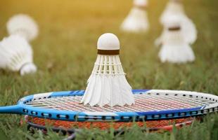 Badminton outdoors equipments shuttlecocks and badminton rackets, on grasslawn, soft and selective focus on shuttlecocks, outdoor badminton playing concept photo