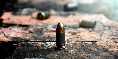 9mm pistol bullet shells on brick floor, soft and selective focus, concept for searching a key piece of evidence in a murder case at the scene. photo