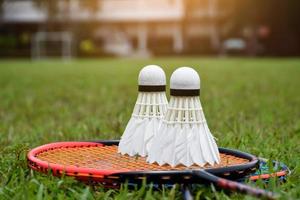 Badminton outdoors equipments shuttlecocks and badminton rackets, on grasslawn, soft and selective focus on shuttlecocks, outdoor badminton playing concept photo