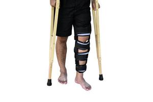 Isolated a broken-legged man holding crutches and a cloth wrapped around his leg with clipping paths. photo