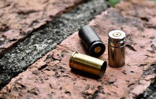 9mm pistol bullet shells on brick floor, soft and selective focus, concept for searching a key piece of evidence in a murder case at the scene. photo