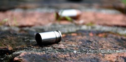 9mm pistol bullet shells on brick floor, soft and selective focus, concept for searching a key piece of evidence in a murder case at the scene. photo