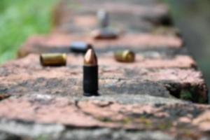 9mm pistol bullet shells on brick floor, soft and selective focus, concept for searching a key piece of evidence in a murder case at the scene. photo