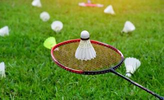 Outdoor badminton playing equipments on green lawn. photo