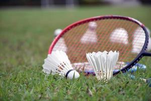 Outdoor badminton playing equipments on green lawn. photo