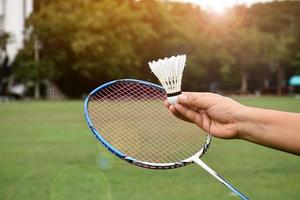 Badminton outdoors equipments shuttlecocks and badminton rackets, on grasslawn, soft and selective focus on shuttlecocks, outdoor badminton playing concept photo