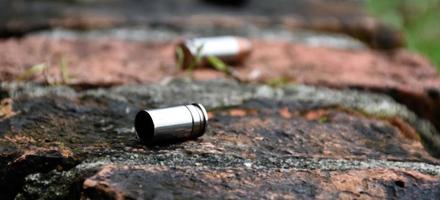 9mm pistol bullet shells on brick floor, soft and selective focus, concept for searching a key piece of evidence in a murder case at the scene. photo