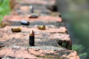 9mm pistol bullet shells on brick floor, soft and selective focus, concept for searching a key piece of evidence in a murder case at the scene. photo