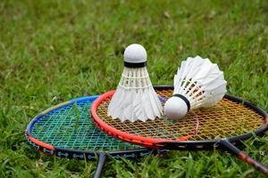 Badminton racket and badminton shuttlecock against cloudy and bluesky background, outdoor badminton playing concept. selective focus on racket. photo