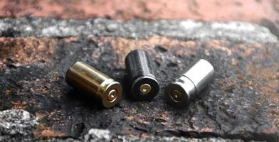 9mm pistol bullets and bullet shells on brick floor, soft and selectivec focus. photo