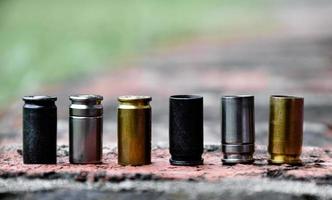 9mm pistol bullet shells on brick floor, soft and selective focus, concept for searching a key piece of evidence in a murder case at the scene. photo