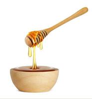 Honey dripping isolated on a white background, Dripped honey, Honey dipper photo