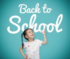 Asian child girl pointing at the blackboard with imagination the Back to School text, Creative and dreams of childhood concept photo