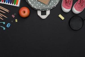 Top view mockup of Education's accessories with backpack, student books, shoes, colorful crayon, pencil, empty space on blackboard background, Concept of education and back to school photo