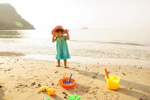 Little girl running in sea water on the beach. photo