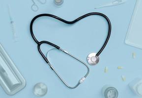 Stethoscope in shape of heart with medical documents, thermometer, syringe and pills on blue table background, Good health from Doctor concept, Top view with copy space, Isolated on blue photo