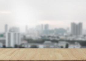 Empty wooden table top with view of city or wooden desk with cityscape with blur background, copy space for your text photo