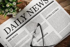 Newspaper with the headline News and glasses on wooden table, Daily Newspaper mock-up concept