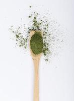 Matcha green tea powder in spoon isolated on white background creative flat lay, Organic product from the nature for healthy with traditional style photo