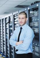 young it engineer in datacenter server room photo