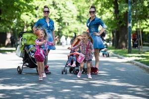 twins mother with children  in city park photo