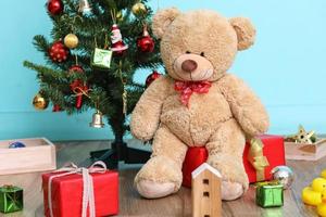 Christmas tree, flag and Christmas decorations with toy teddy bear on blue background, Happy New Year on 2017 photo