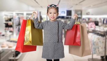 compras joven asiática sosteniendo bolsas de compras en la tienda del centro comercial fondo borroso, concepto de estilo de vida de marketing digital de comercio electrónico foto