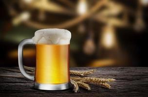 Glass of Light Beer with wheat on the wooden table in the restaurant, with copy space for your text photo