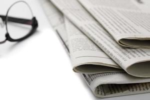 Mockup of Business Newspaper with glasses isolated on white background photo