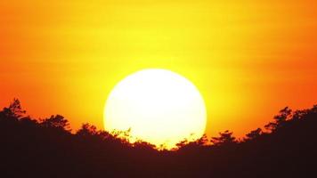 Close up view of sun setting beyond the horizon. video