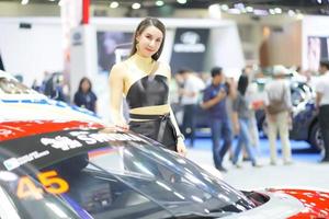 Nonthaburi, Thailand - DEC 3, 2019 Unidentified model poses with a car at The 36th Motor Expo Thailand 2019 at IMPACT Arena, Muang Thong Thani, Nonthaburi, Thailand. photo