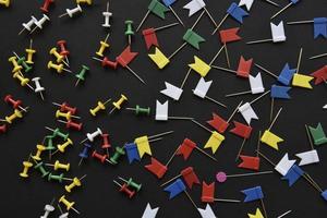 Multicolored plastic power buttons on a black background. Beautiful close-up stationery buttons. photo